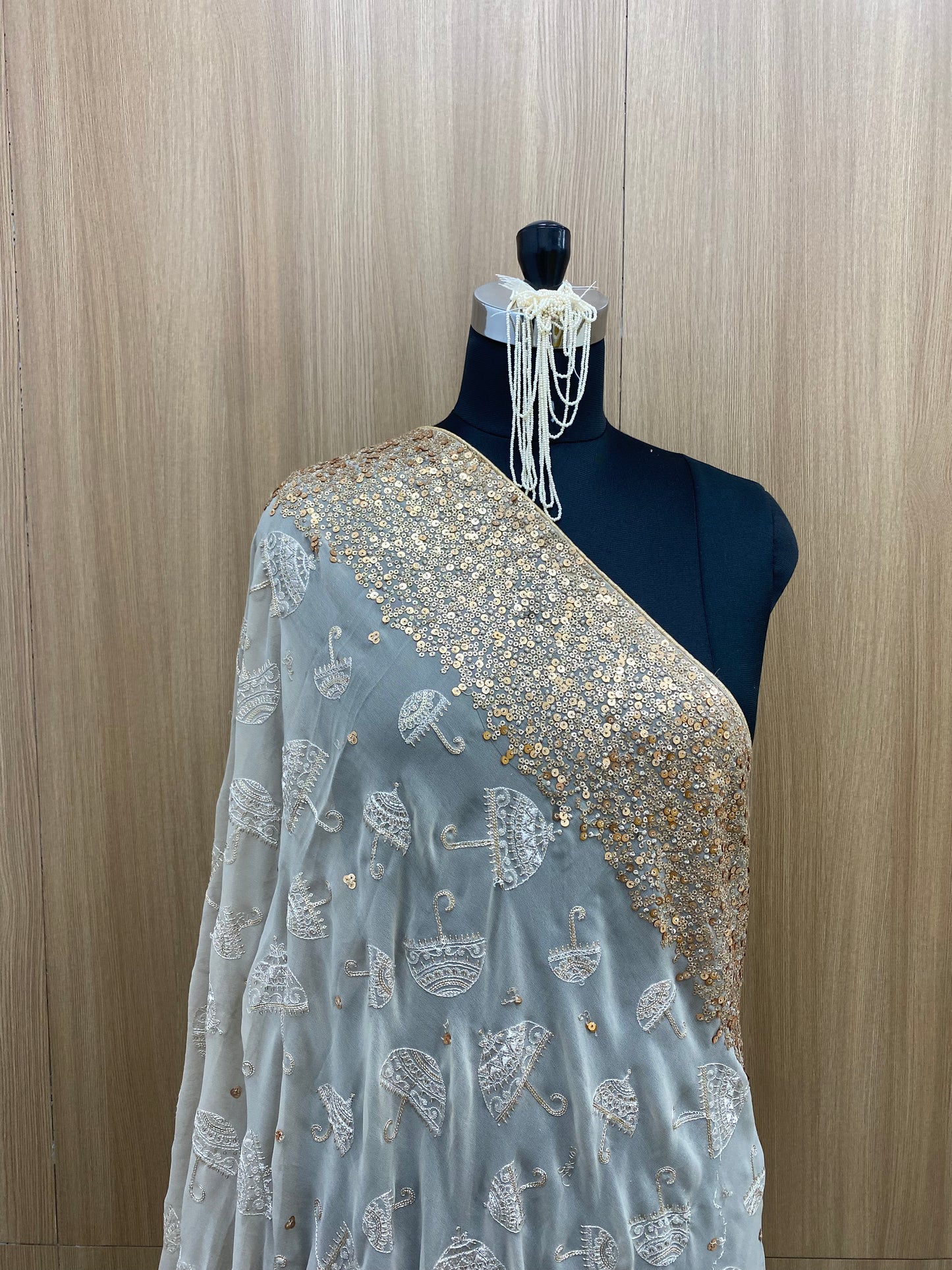 Elegant Sparkling Umbrella Shaped Thread Embroidery With Shiny Golden Sequin And Zari Work On Georgette Fabric