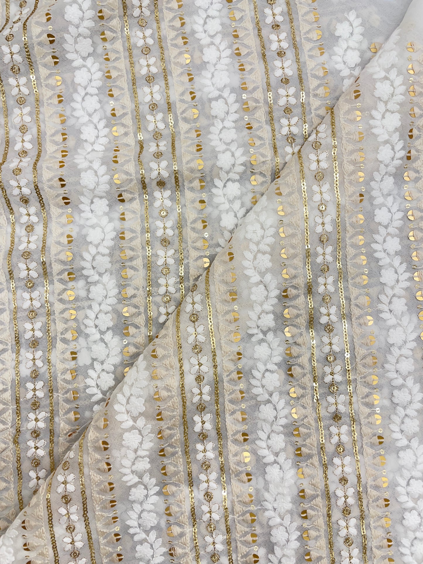 Luxurious Adorable White And Off White Thread Embroidery With Sequin Work On White Dyeable Georgette Fabric