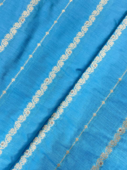 Fabulous Eye Catching Ethnic Dainty Floral And Parallel Line Zari Weaving On Munga Silk Fabric