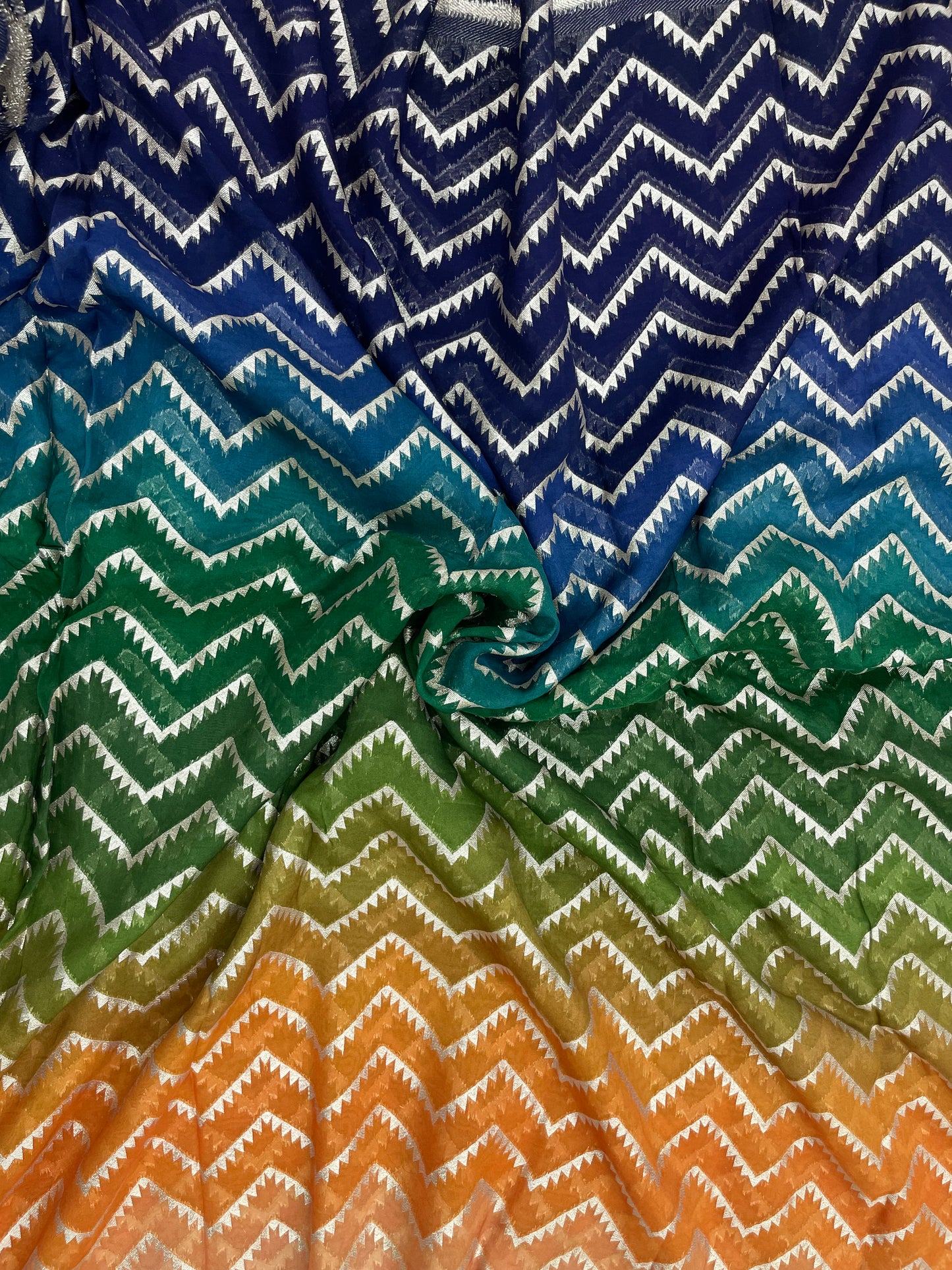 Unique Eye Catching Multi Color Print With Zig Zag Golden Zari Work On Organza Fabric